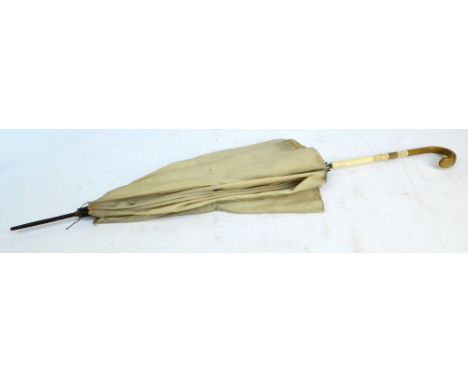 A rhino horn and ivory handled silk parasol, with maker's plaque "Lawtex" to the inside, length 79cm (top af). CONDITION REPO