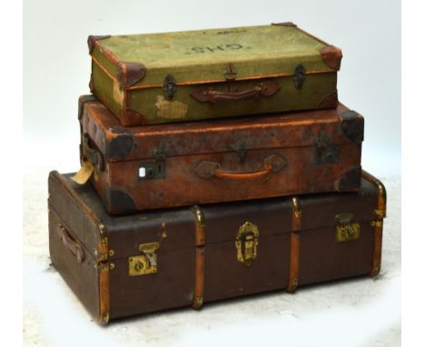 A collection of vintage luggage comprising a green canvas suitcase with leather corners and straps inscribed "Papworth Indust