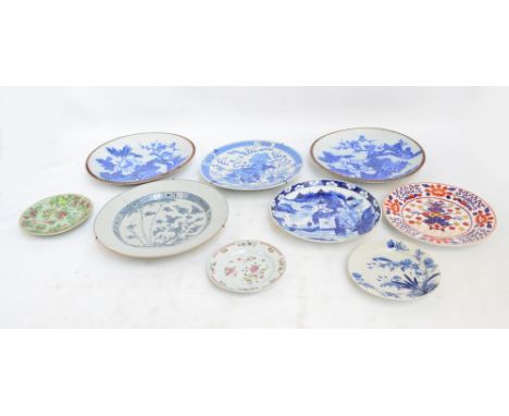 A group of 18th and 19th century Chinese and Japanese plates to include two examples painted in enamels with floral sprays, b
