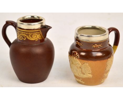 A small George V hallmarked silver rimmed Doulton Lambeth jug, maker's mark rubbed, Chester 1913, height 7cm, and a further h