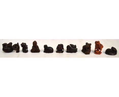 Nine hardwood netsukes depicting various animals including a monkey, a water buffalo, frogs, mushrooms, two figural examples,