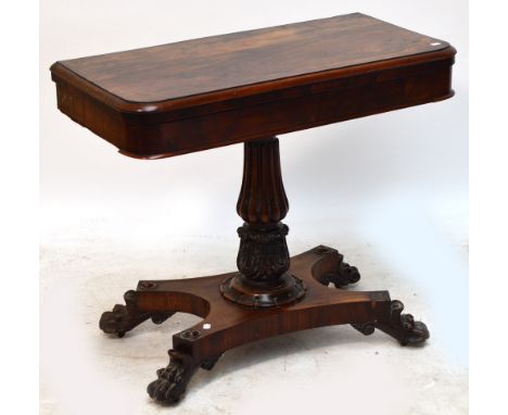 A William IV rosewood card table with rounded rectangular hinged playing surface above lobed central column to acanthus carve