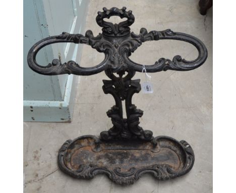 A cast iron two section stick stand with foliate scroll decoration. CONDITION REPORT: Some rust and general wear but basicall