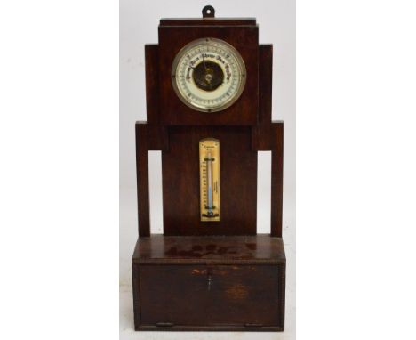 A 1920s oak barometer/thermometer with single hinged flap to the oak case, height 48cm.