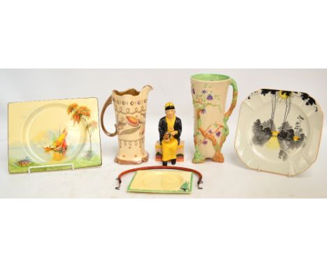 A small collection of ceramics comprising a Clarice Cliff Newport Pottery handled vase, decorated with tree branches and flow