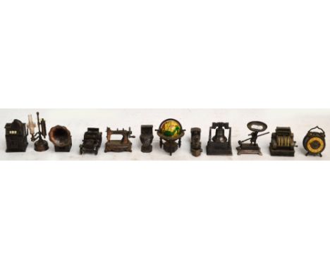 A collection of twelve metal pencil sharpeners including examples in the form of a gramophone, a globe, a sewing machine, a t