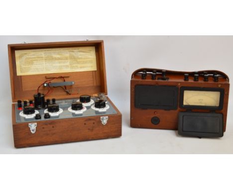 A combined volt meter and watt meter in a wooden case, the dial marked "Evershed & Vignoles Ltd No 385070" and with military 