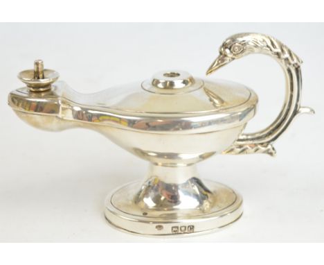 A Victorian hallmarked silver table lighter modelled as a Roman oil lamp with C-scroll handle decorated with cast swan's head