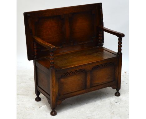 An early 20th century oak monks bench raised on squat turned feet, width 91.5cm.