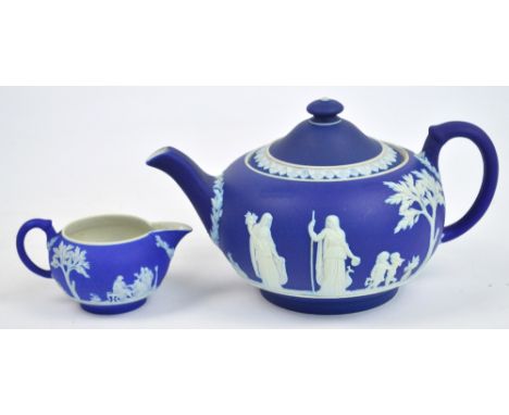 An early 20th century Wedgwood blue jasperware teapot decorated in relief with classical figures, length 24cm, impressed "Wed