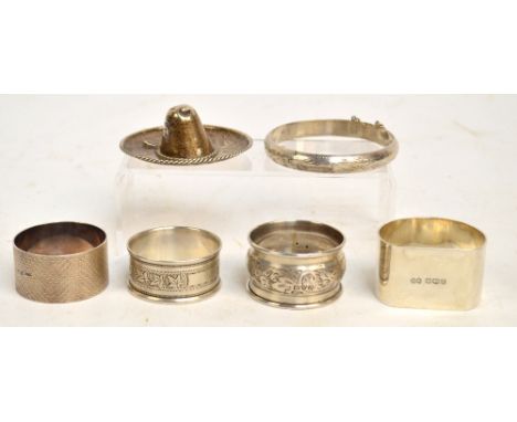 Two George VI hallmarked silver napkin rings comprising a circular example with engine turned decoration, James Swann & Son, 