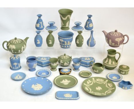 A quantity of blue and pale green Wedgwood jasper ware to include a three piece tea set, various vases, a pair of candlestick