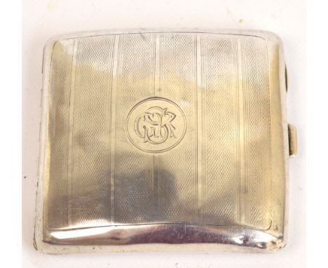 A George V hallmarked silver cigarette case of rounded rectangular form with overall engine turned decoration, centred with a