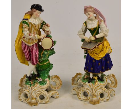 A pair of early 19th century Derby figures of musicians, he wearing pink and red striped breeches and playing the drum, she w