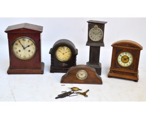 A small collection of clocks comprising an early 20th century German mantel clock with movement by Jahresuhrenfabrik, two dom