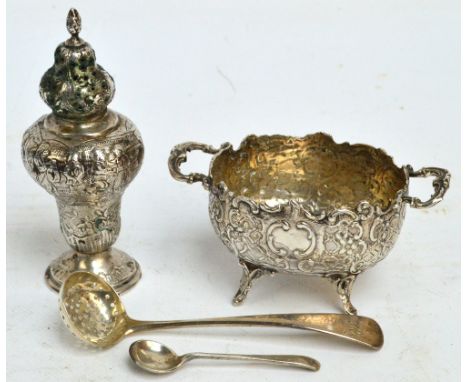 An early 20th century German silver twin handled oval open salt overall decorated with scrolls and motifs, on four cast outsw