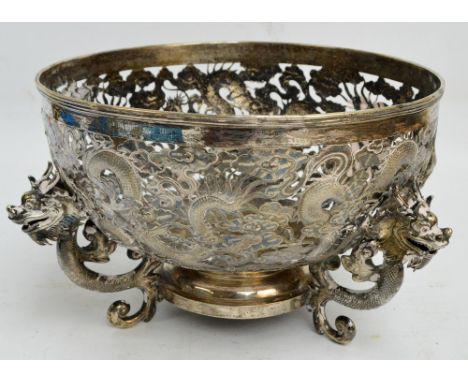 A late 19th century Chinese Export silver punch bowl, overall pierced and decorated with chasing dragons amongst clouds, cent