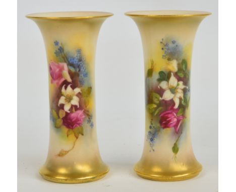 A pair of Royal Worcester blush ivory vases with gilt edged outswept rims painted with roses and other flowers, unsigned, Gra