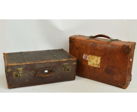 A "Revelation" leather suitcase with reinforced corners, maker's plate, maker's labels, and linen internal straps, stencilled