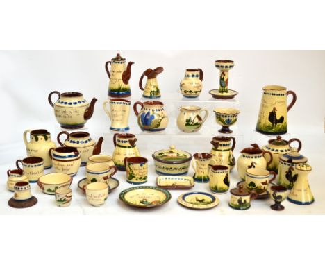 A collection of Torquay Mottoware, comprising predominantly jugs and teapots, also a candlestick, jam pot, plates etc. CONDIT