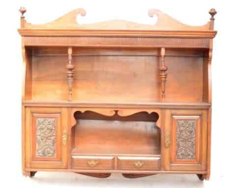 An Edwardian walnut wall hanging shelf.