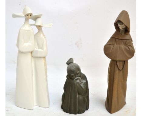 Three Lladro figures; a figure group of two nuns, a matt glazed figure of a monk and a matt glazed figure of a Chinese elderl