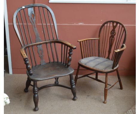 A 19th century ash and elm high hoop back Windsor elbow chair with saddle seat and crinoline stretcher (af), a small wheel, s