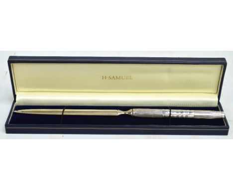 A cased Elizabeth II hallmarked silver handled letter opener, with perpetual calendar and engine turned decoration to the han