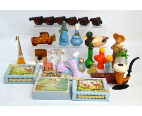 A large collection of Avon glass and plastic bottles including glass cannon bottles, a glass vintage car bottle, figural bott