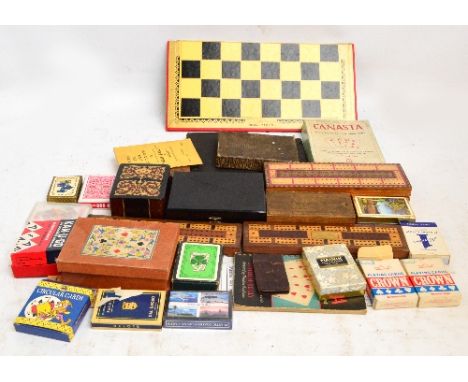 A quantity of various games including three cribbage boards, playing cards, bezique etc.