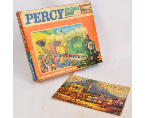 A boxed Meccano "Percy - The Small Engine" clockwork/push along train set and a Coronation cut-out story book (2).