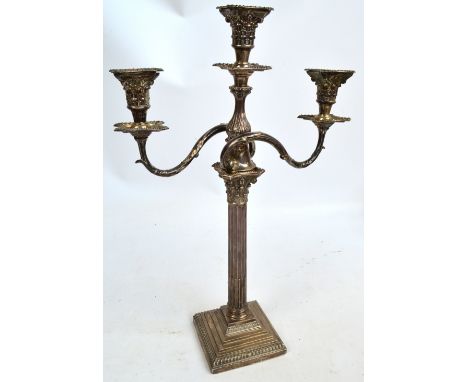 A George V hallmarked silver three branch candelabrum convertible to a single candlestick, the sconces modelled as Corinthian