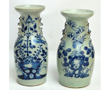 Two large late 19th century Chinese vases of baluster form with handles modelled as temple lions playing, both painted in und