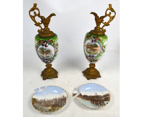 A pair of late 19th century gilded metal and opaque glass bodied decorative urns, hand painted with riverside scenes, flowers