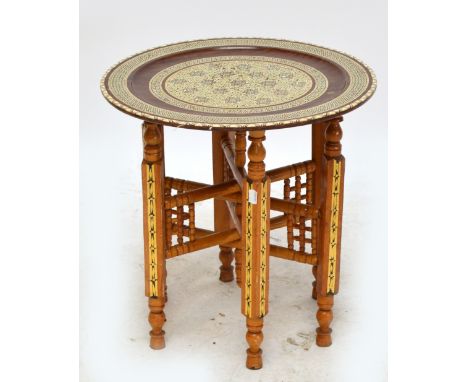 A decorative mother of pearl inlaid circular occasional table raised on folding supports, width 49cm.