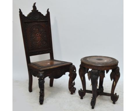 An early 20th century Eastern carved hardwood side chair and a circular occasional table raised on four elephant trunk suppor