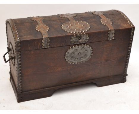 A large oak strap bound domed twin handled trunk, width 122cm, height 76cm.