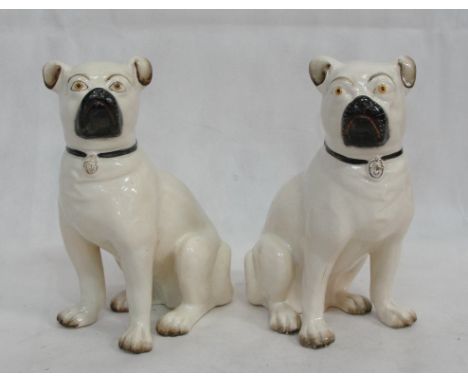 A pair of ceramic pug figures