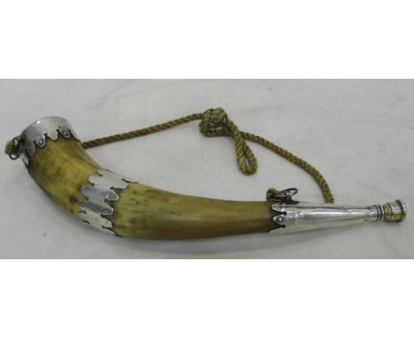 A horn bugle with white metal mounts