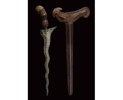 dating: 19th Century provenance: Madura Island, Undulated, double-edged blade made of fine pamor, carved base with light full