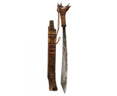 dating: circa 1900 provenance: Kalimantan, Solid, curved, single-edged blade. Sculpted, wooden hilt, the base with vegetal fi