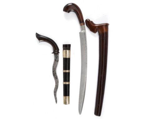 dating: circa 1900 provenance: Indonesia, A Badik with an undulating blade and a carved horn grip, wooden scabbard with horn 