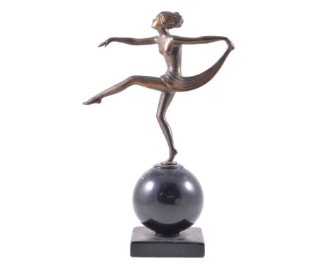 An Art Deco 'Scarf Dancer', manner of Josef Lorenzl, patinated spelter, raised on a blackened globe base, 32cm.