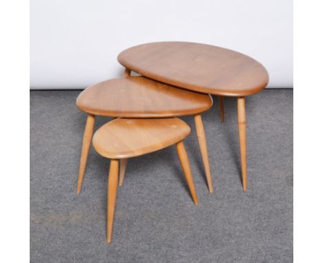 Ercol, a nest of three ‘Pebble’ tables, shape 354, elm and beech, largest width 68cm, height 40cm (3)