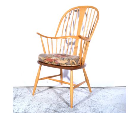 Ercol, a 'Chairmaker's' Windsor armchair, shape 472, removable seat pad, applied gilt and brown label, width 62cm, height 107