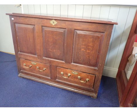 AN 18TH CENTURY OAK MULE CHEST with three fielded panel s over two drawers 121 cm wide x 90 cm high