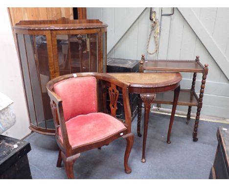 AN EDWARDIAN TUB CHAIR a 1930s glazed display cabinet, a stndard lamp with shade, a demi-lune table and an oak trolley (5) 