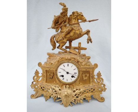 A 19TH CENTURY FRENCH SPELTER CLOCK striking on a bell, the gilt case surmounted by a warrior on a horse 39 cm high 