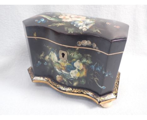 A VICTORIAN PAPIER MACHE TEA CADDY with original floral and gilt decoration on turned ivory feet, 19.5cm wide