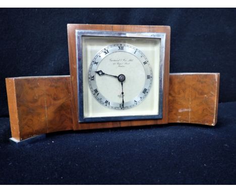A 1950S 'ELLIOTT' CLOCK RETAILED BY GARRARD &amp; CO in an Art Deco style walnut and chrome case (not working, some wear to c